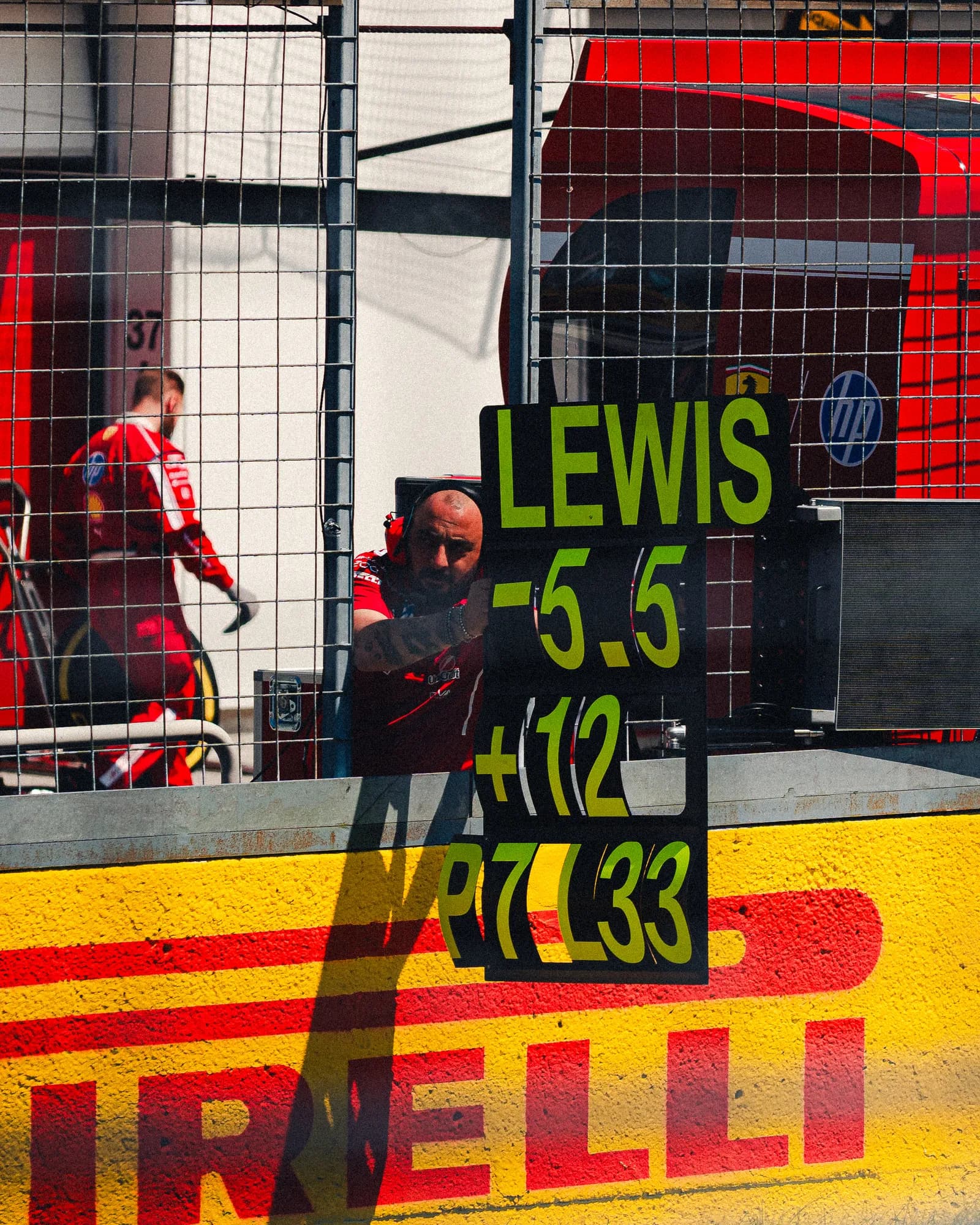 Ferrari pit board for Lewis Hamilton hung over the pit wall