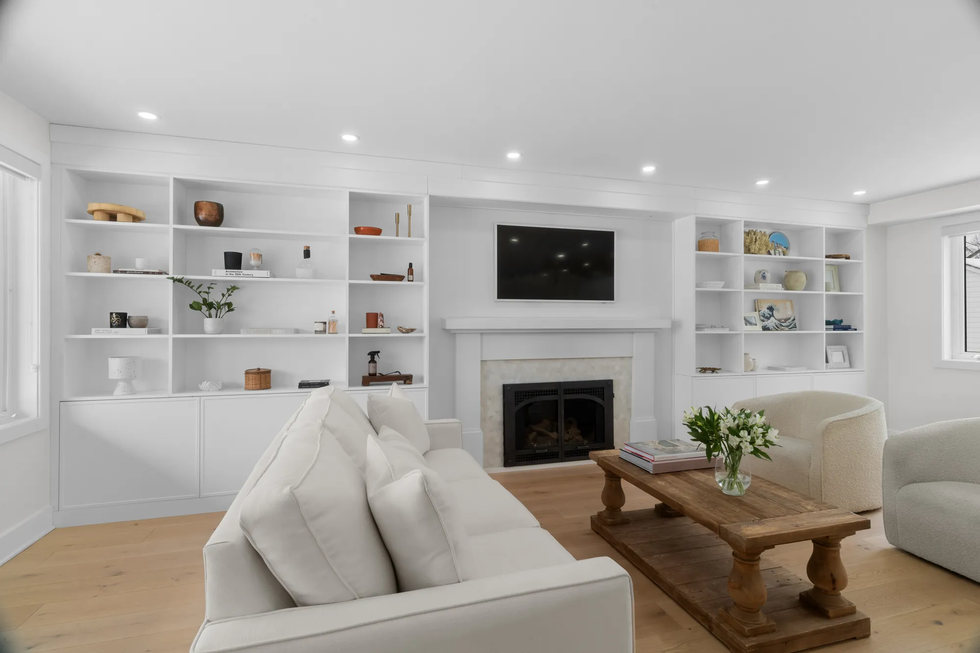 Living room with built-in shelving around the fireplace