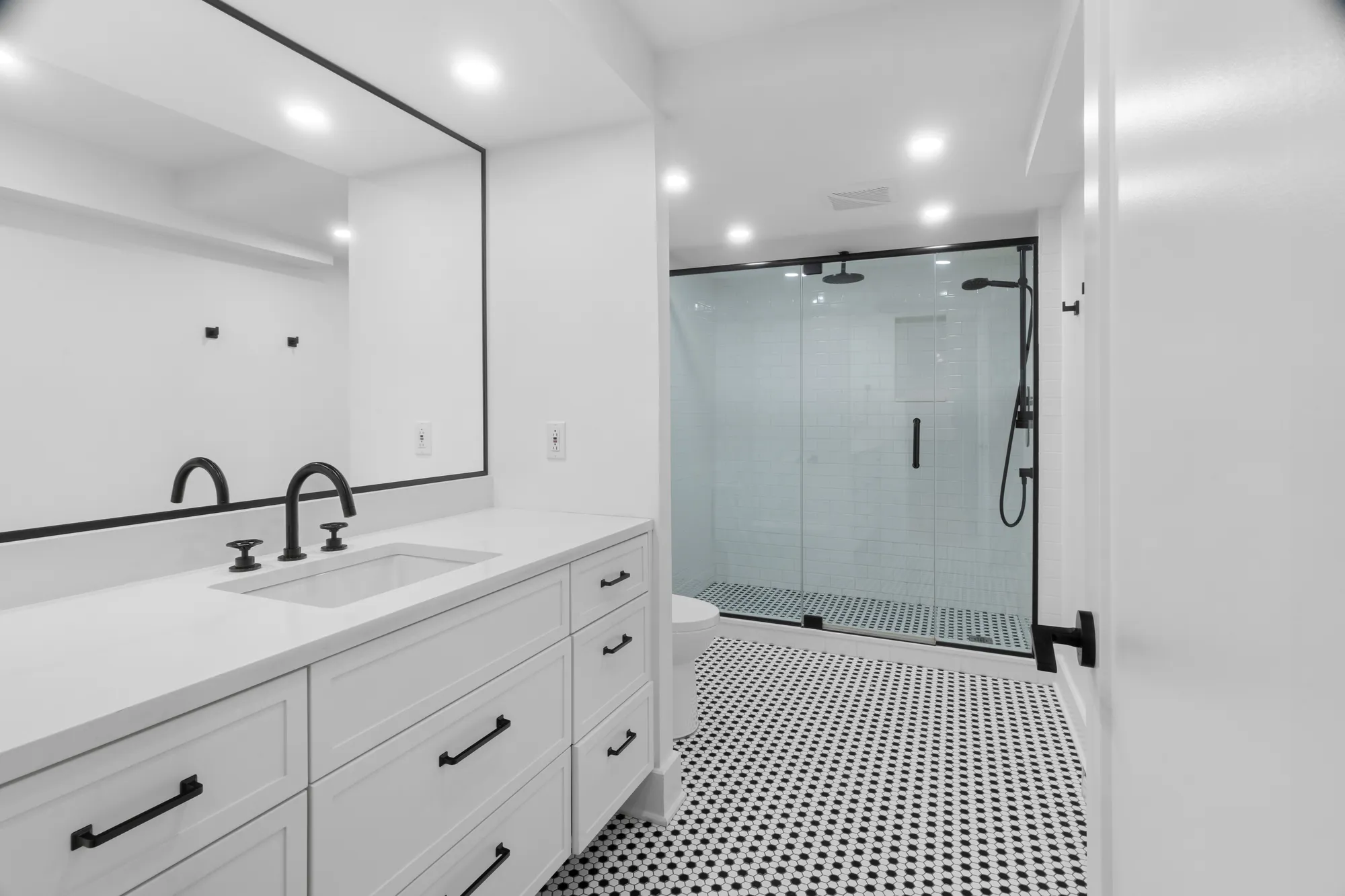 Bathroom with mosaic tile floor and glass shower