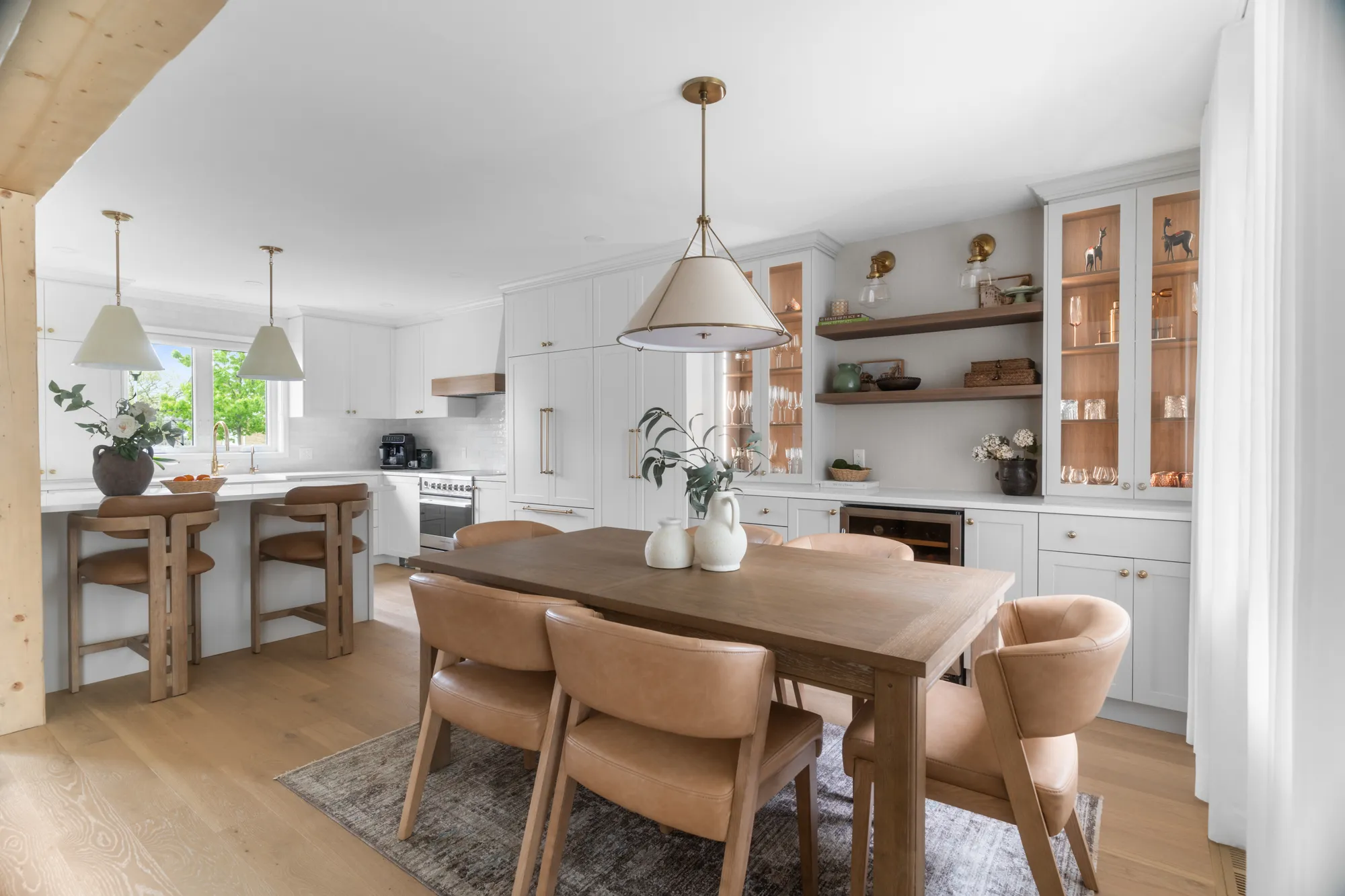 Open kitchen and dining room with exposed wood beam and pendant lighting at 22 Rue Magil