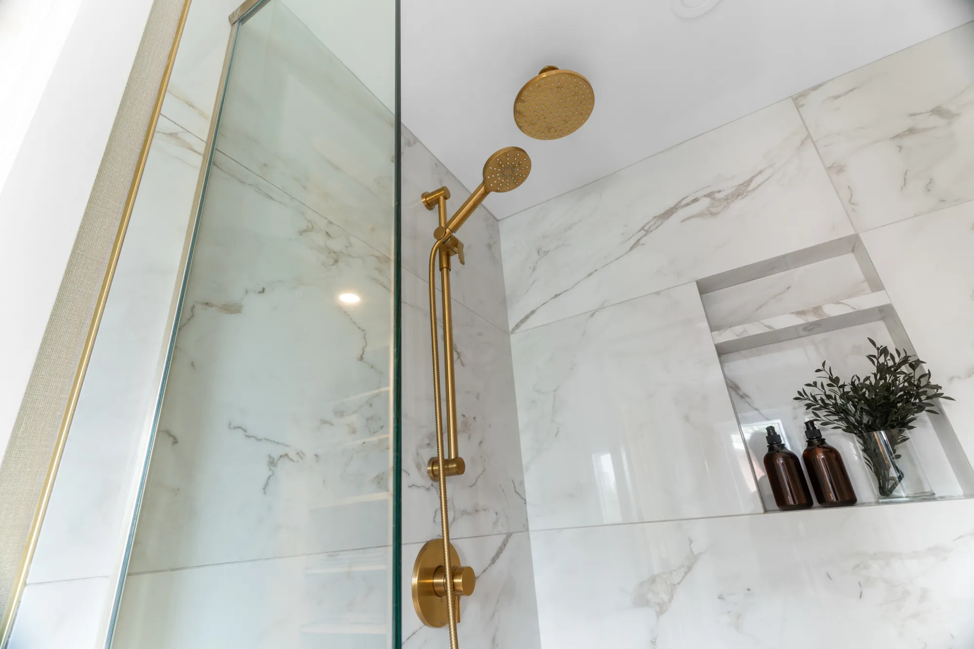 Marble shower detail with brass fixtures